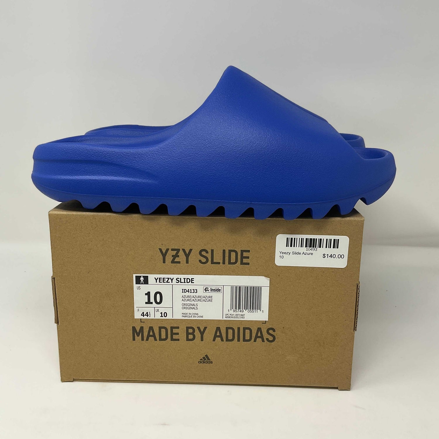 adidas Yeezy Slide Azure in blue on box with size 10 and price tag