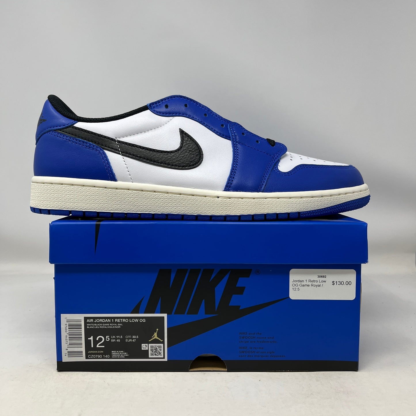 Jordan 1 Retro Low OG Game Royal sneaker in blue, white, and black on blue Nike box