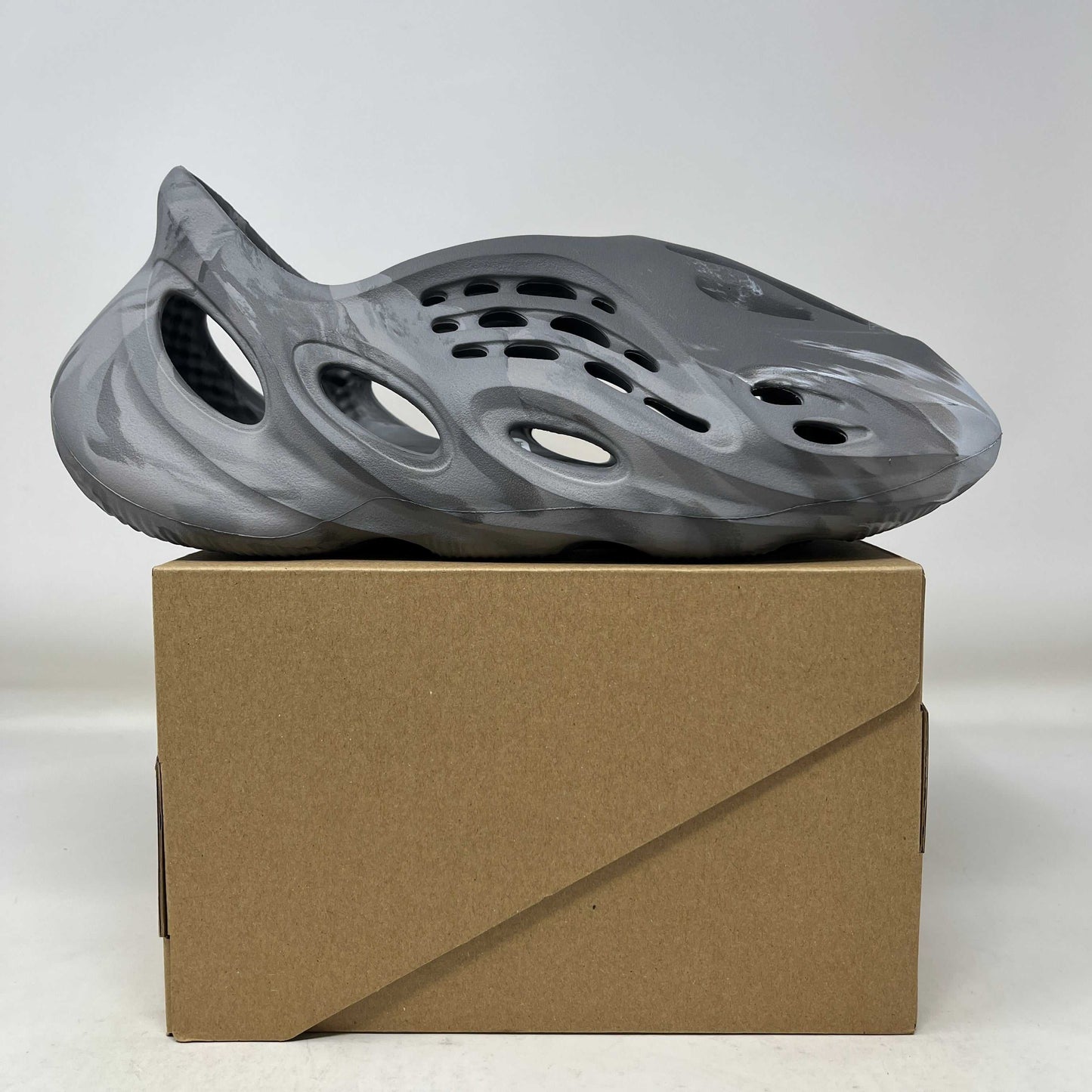 adidas Yeezy Foam RNR MX Granite gray slip-on shoe on cardboard box