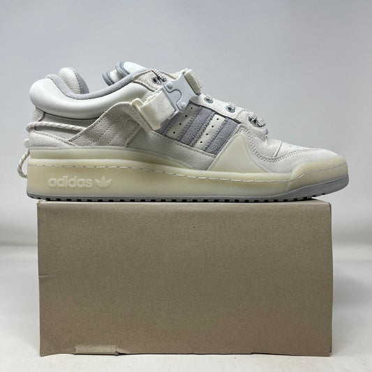 Side view of the adidas Forum Buckle Low Bad Bunny Last Forum sneaker in white and grey on a cardboard box