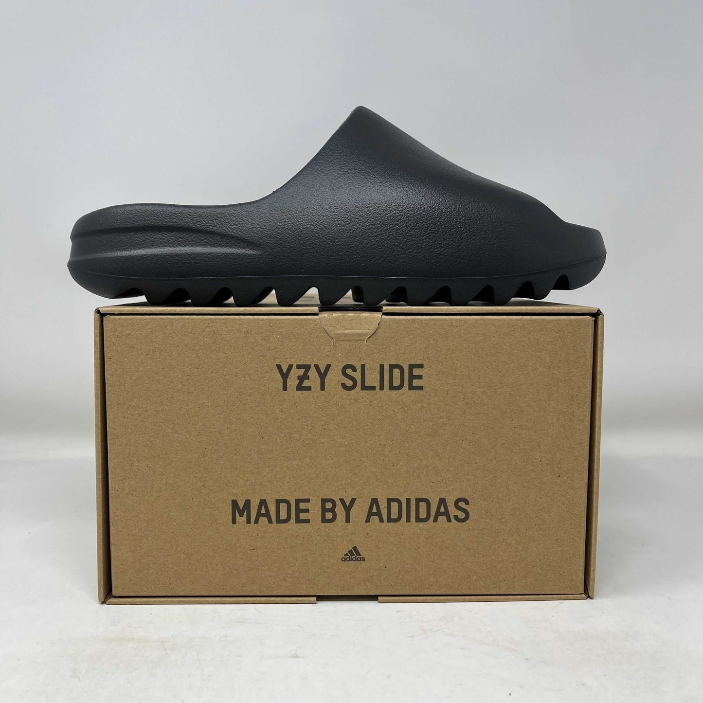 adidas Yeezy Slide Dark Onyx on box with YZY Slide branding
