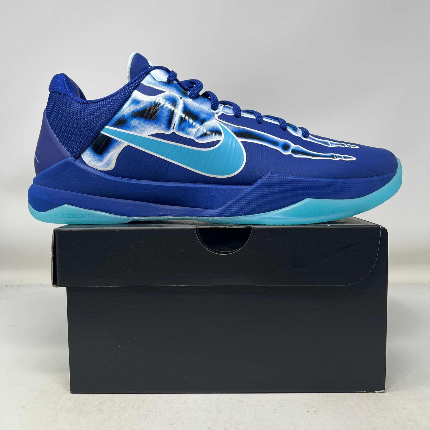 Nike Kobe 5 Protro X-Ray basketball shoe in blue with translucent X-ray design and teal sole on black box