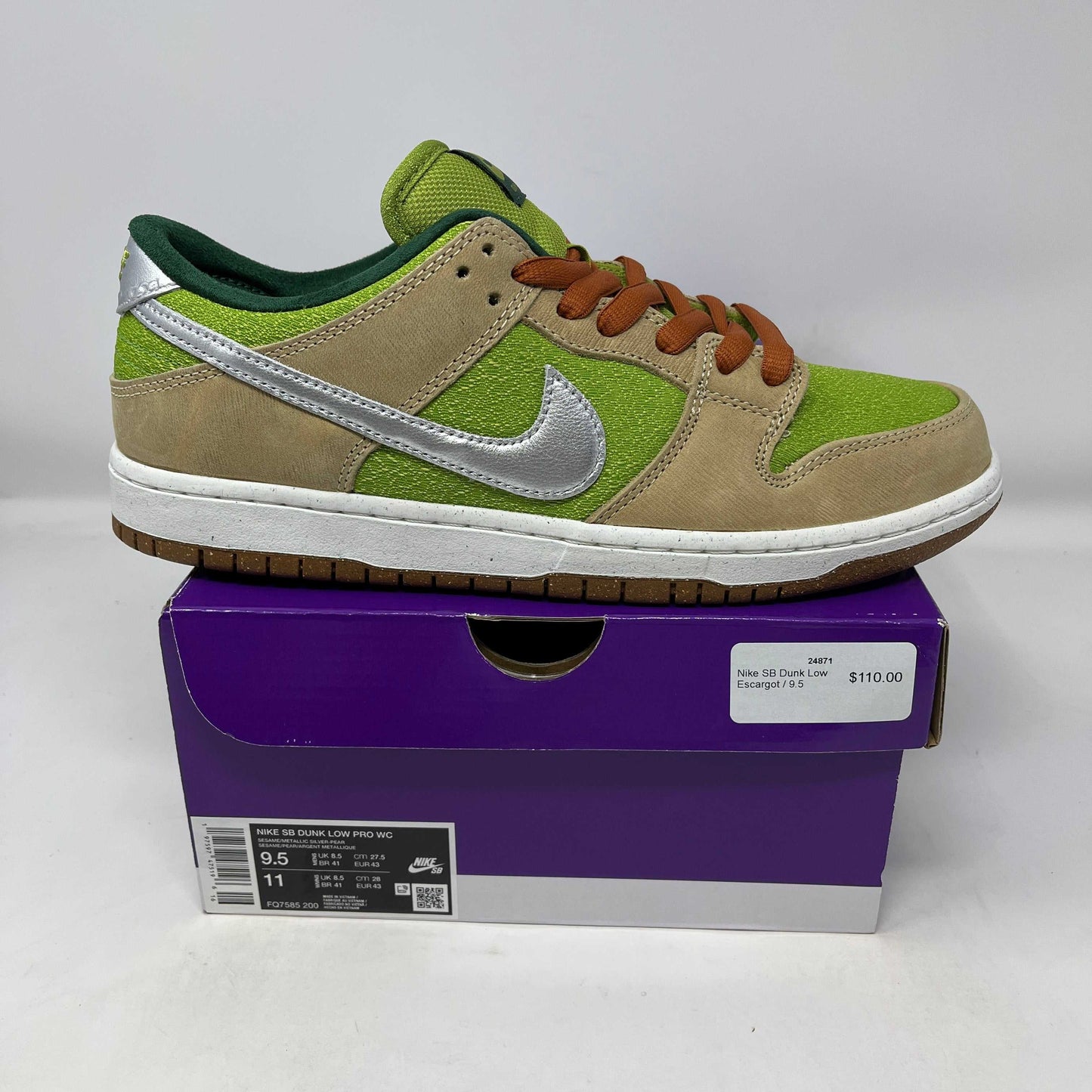 Nike SB Dunk Low Escargot sneaker in green and beige with silver swoosh on purple box