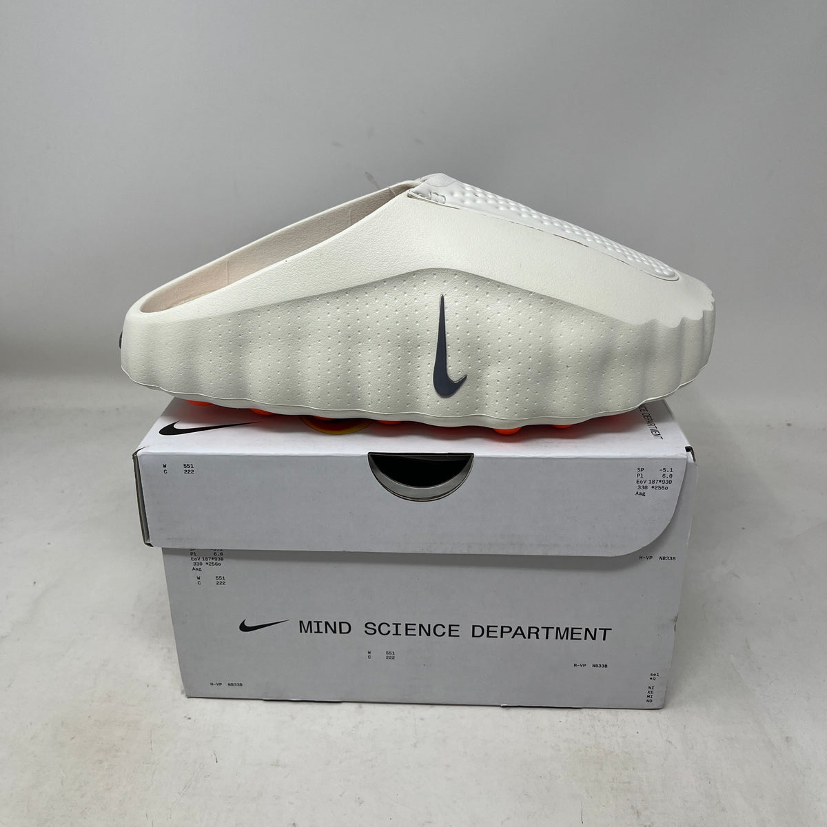 Nike Mind 001 Slide Sail slide in sculpted sail-colored foam, featuring a perforated textured upper and dark Swoosh.