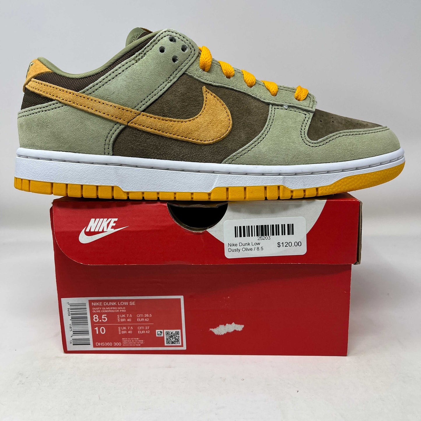 Nike Dunk Low Dusty Olive sneaker in green and mustard on red Nike box with price tag $120