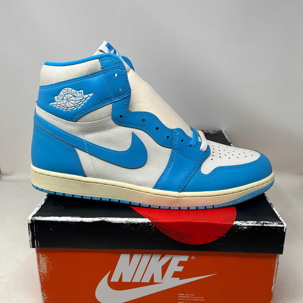 Jordan 1 Retro High OG high-top sneaker with a bright blue and white leather upper, perforated toe, Swoosh and Wings logo.