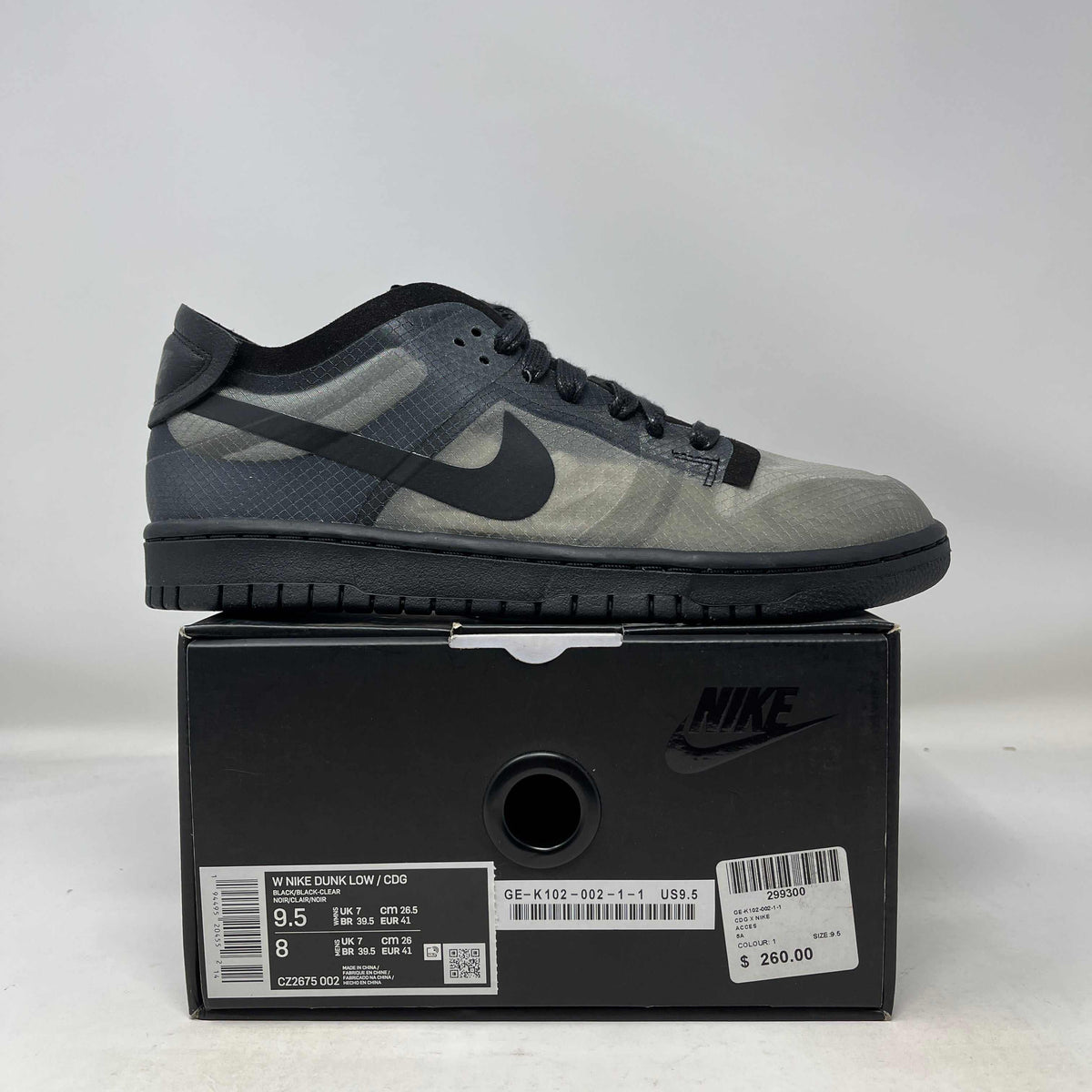 Nike Dunk Low Comme low-top sneaker in charcoal grey patterned mesh and suede, with black Swoosh, laces and sole.