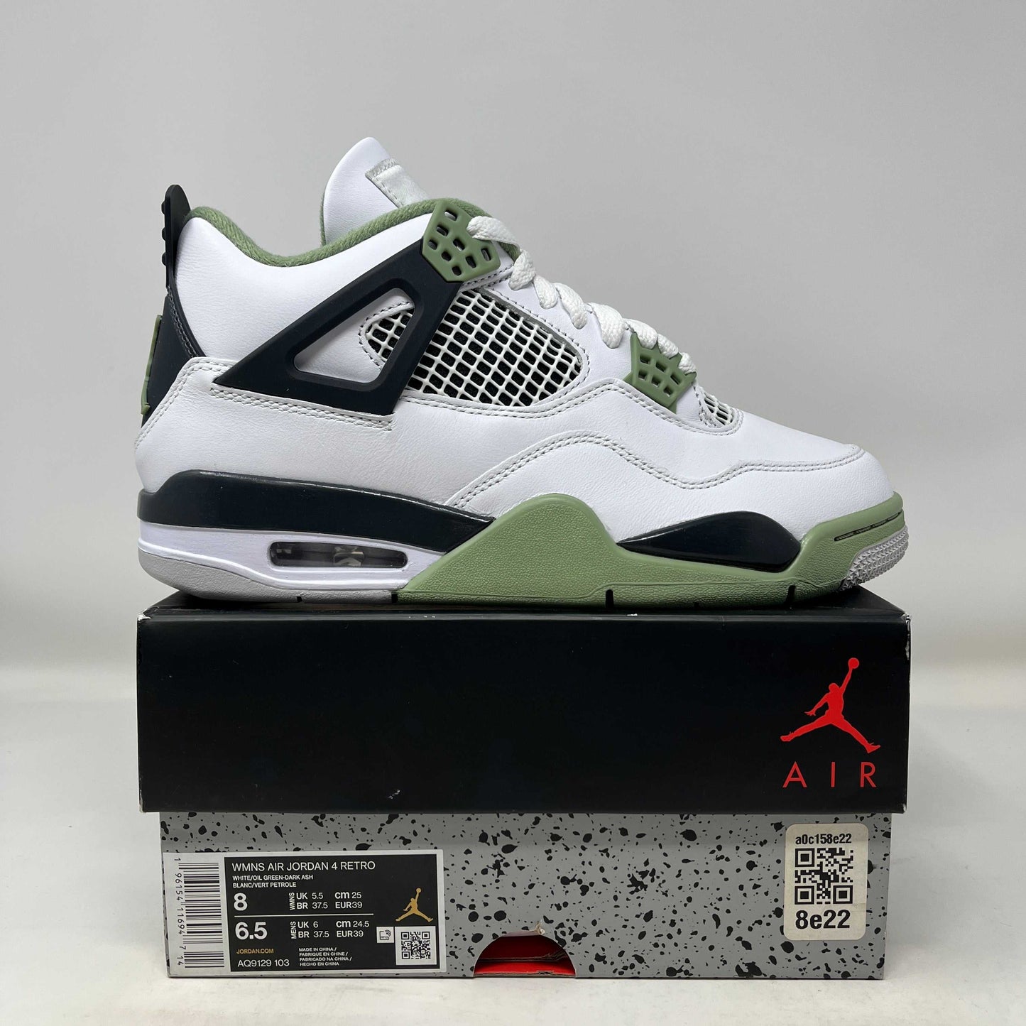 Jordan 4 Retro Seafoam women's sneaker in white and green on top of branded Air Jordan box