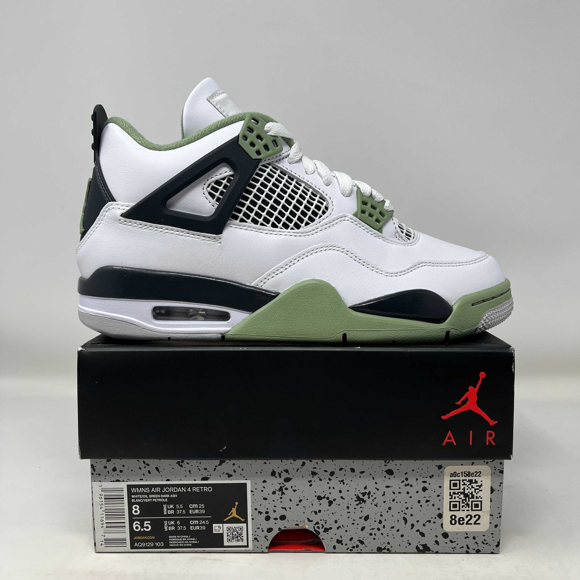 Jordan 4 Retro Seafoam women's sneaker in white and green on top of branded Air Jordan box