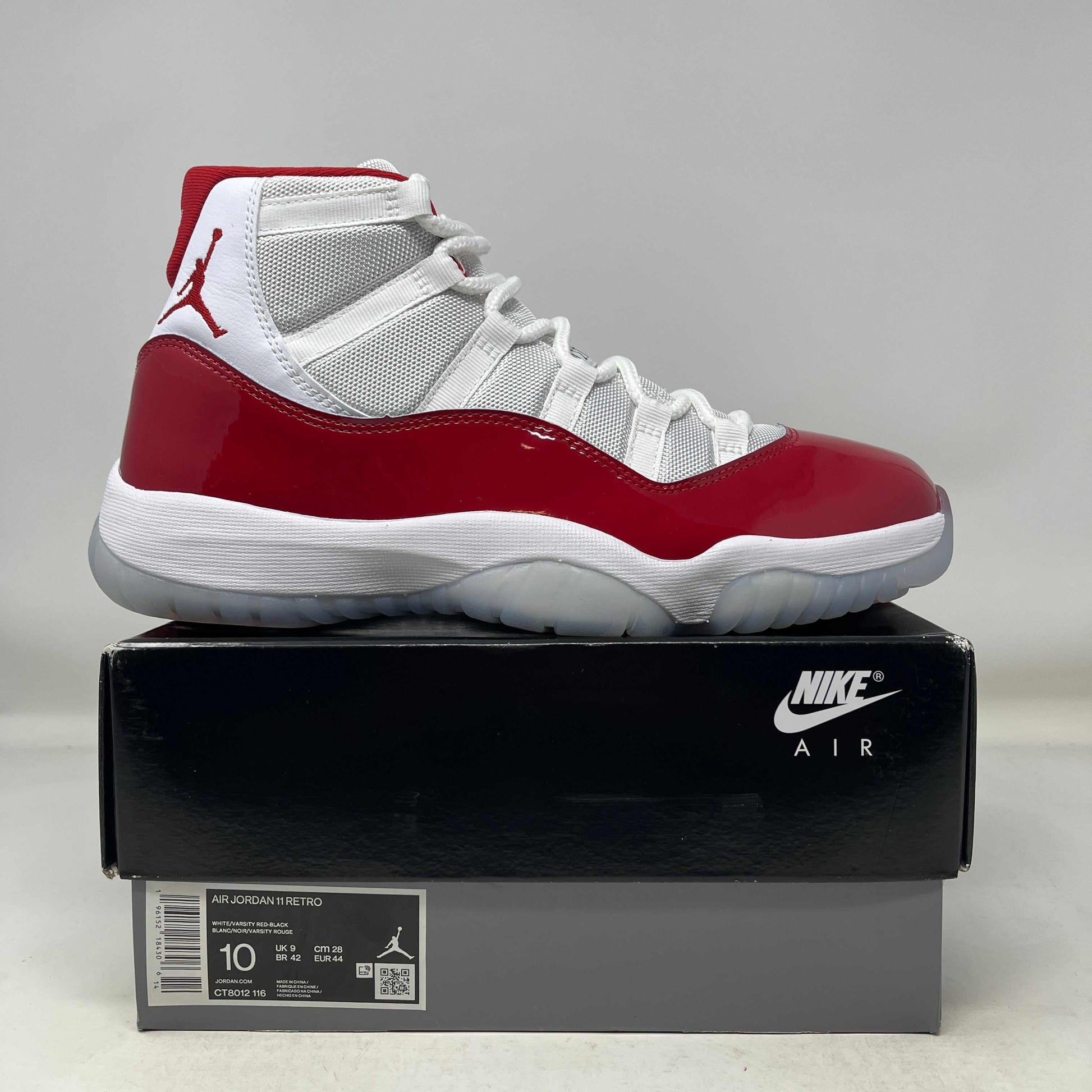 Used Jordan 11 Retro Cherry 2022 sneakers on Nike Air box, size 10, original condition.