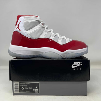 Used Jordan 11 Retro Cherry 2022 sneakers on Nike Air box, size 10, original condition.