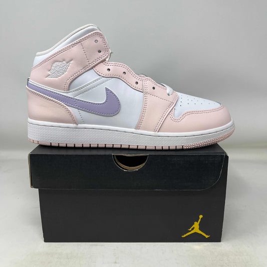 Jordan 1 Mid Pink Wash GS sneaker in pink, white, and lavender on a black Jordan box.
