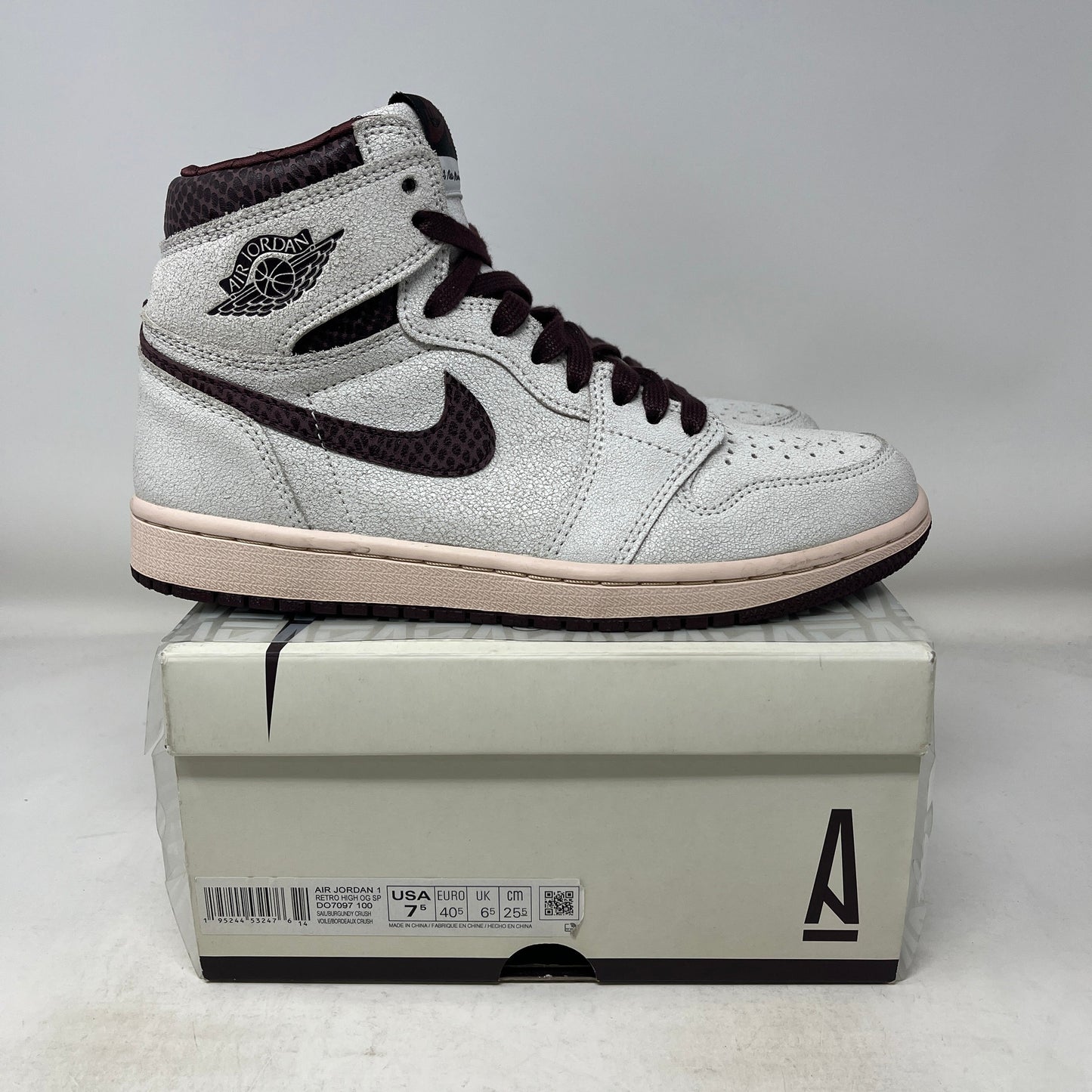 Used Jordan 1 Retro High OG A Ma Maniére sneaker in white and dark brown on a shoebox