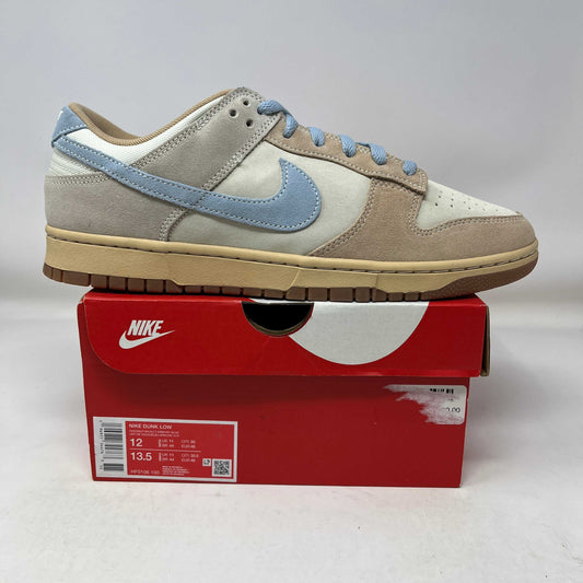 Nike Dunk Low Sanddrift Light Armory Blue sneaker on red Nike box showing side profile