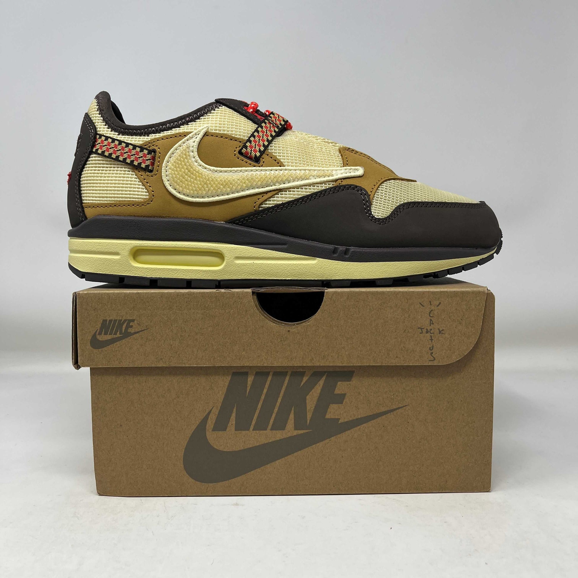 Nike Air Max 1 Travis Scott Cactus Jack Baroque Brown sneaker on Nike box with yellow, brown, and black detailing