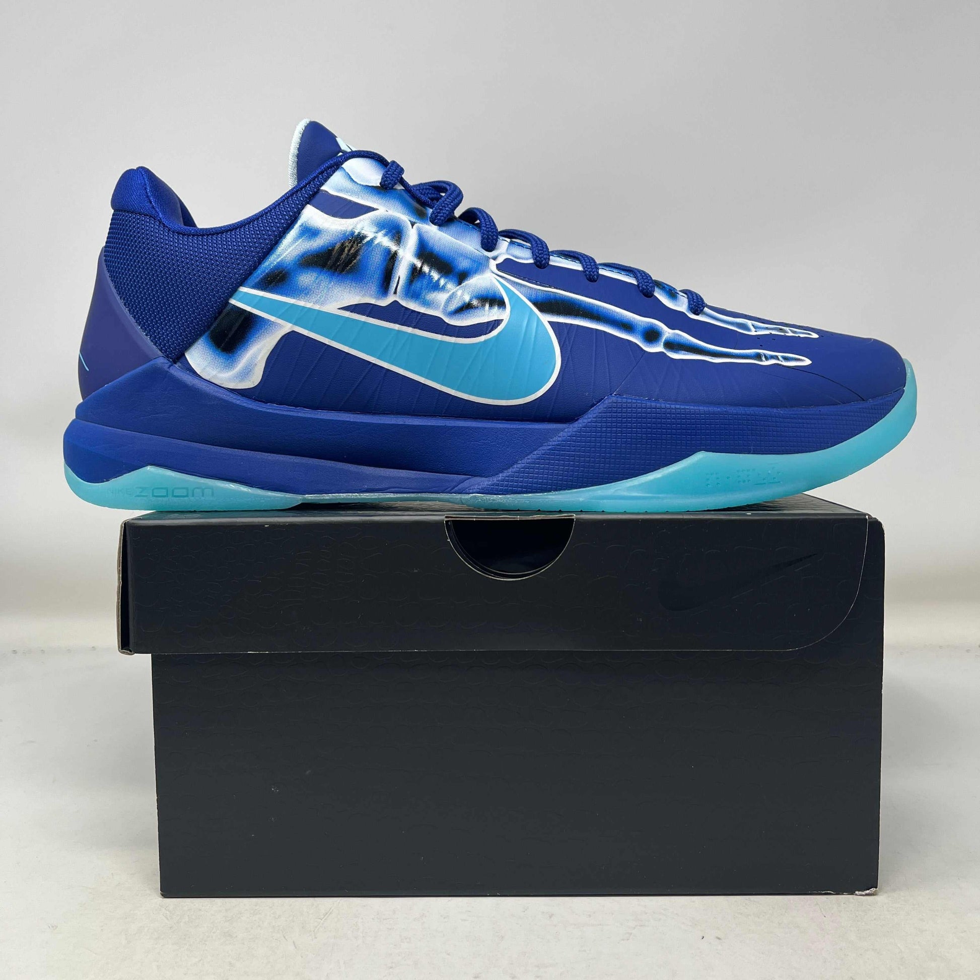 Nike Kobe 5 Protro X-Ray basketball shoe in blue with translucent X-ray design and teal sole on black box