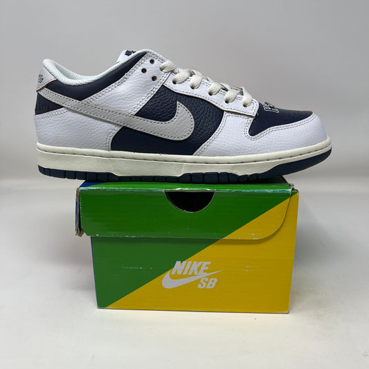 Nike SB Dunk Low HUF New York City sneaker in white and navy on a green and yellow Nike SB box