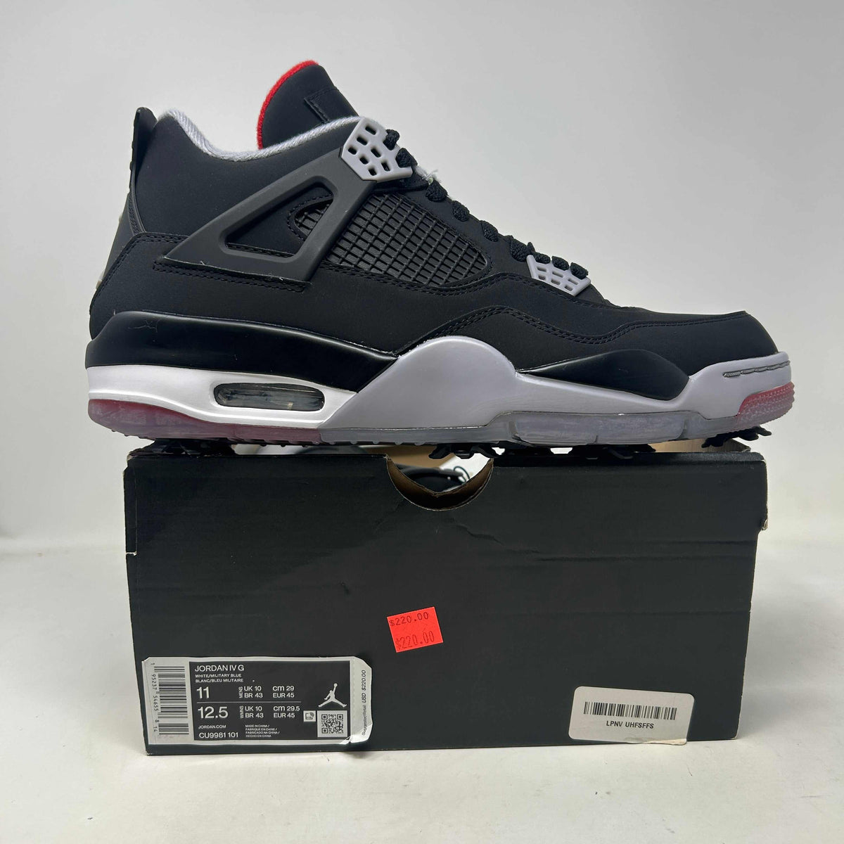 Jordan 4 Retro Golf Bred sneaker in black leather with mesh panels, gray accents, red details and golf traction sole.