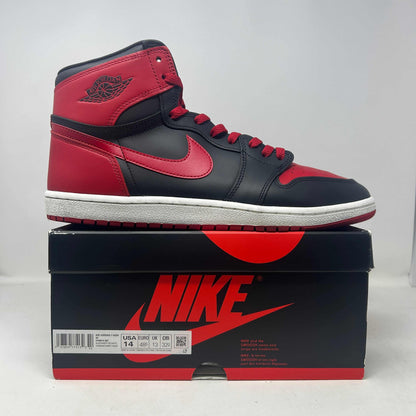 Jordan 1 Retro High '85 OG Bred sneaker in black and red leather, with a high-top silhouette and contrasting Swoosh.