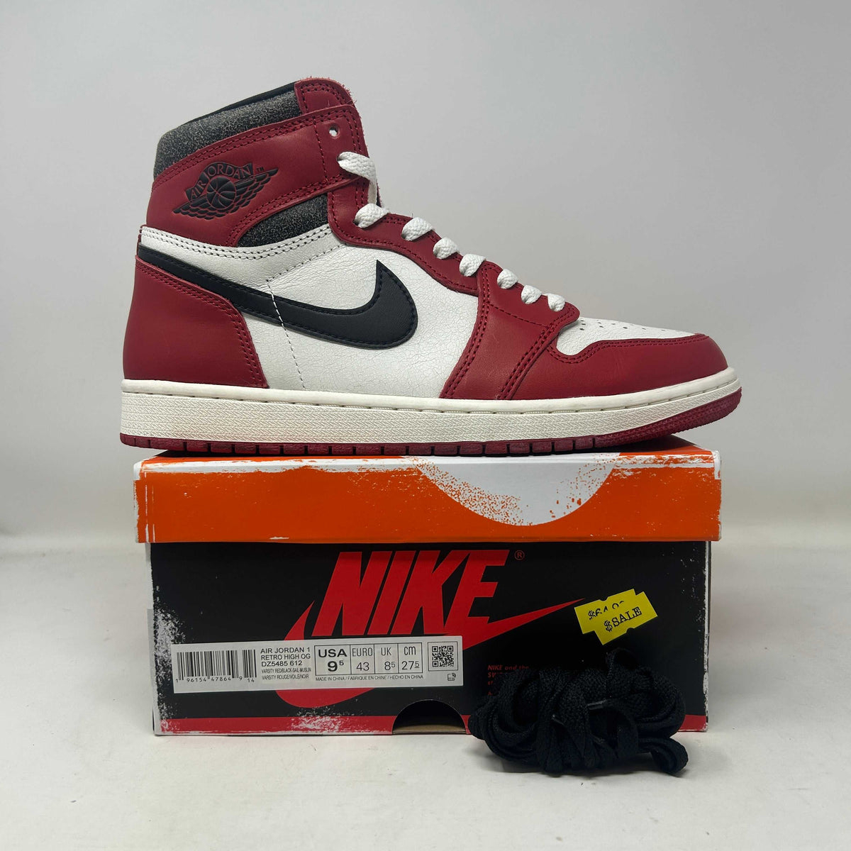 Jordan 1 Retro High OG Chicago high-top sneaker in red, white and black leather with a Swoosh, Wings logo and aged details.