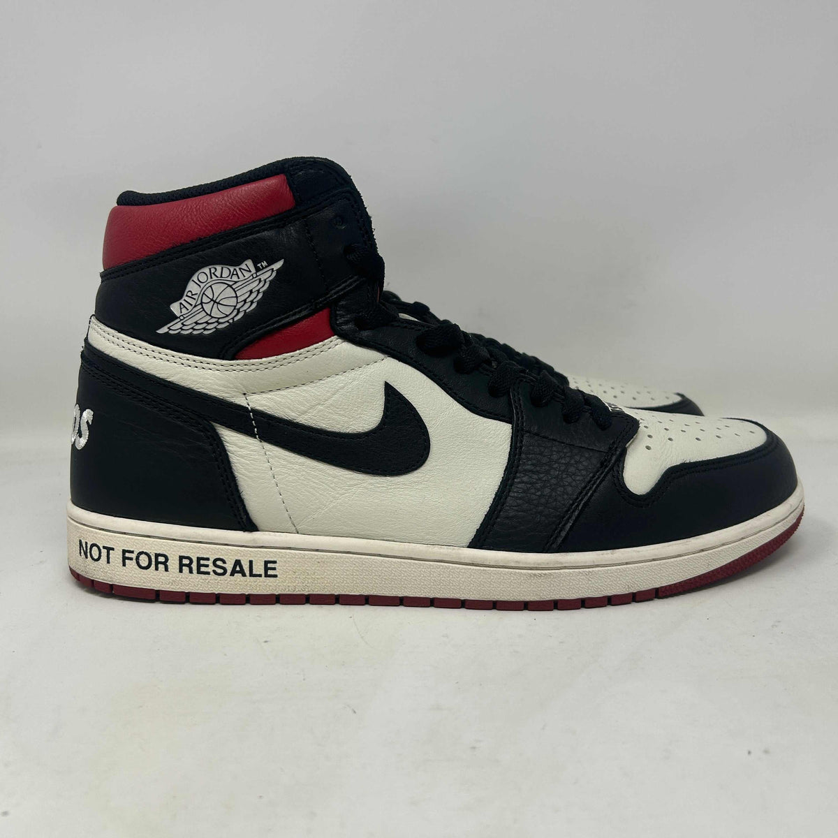 Jordan 1 Retro High Not high-top sneaker in white leather with black overlays, varsity red accents, and NOT FOR RESALE lettering.