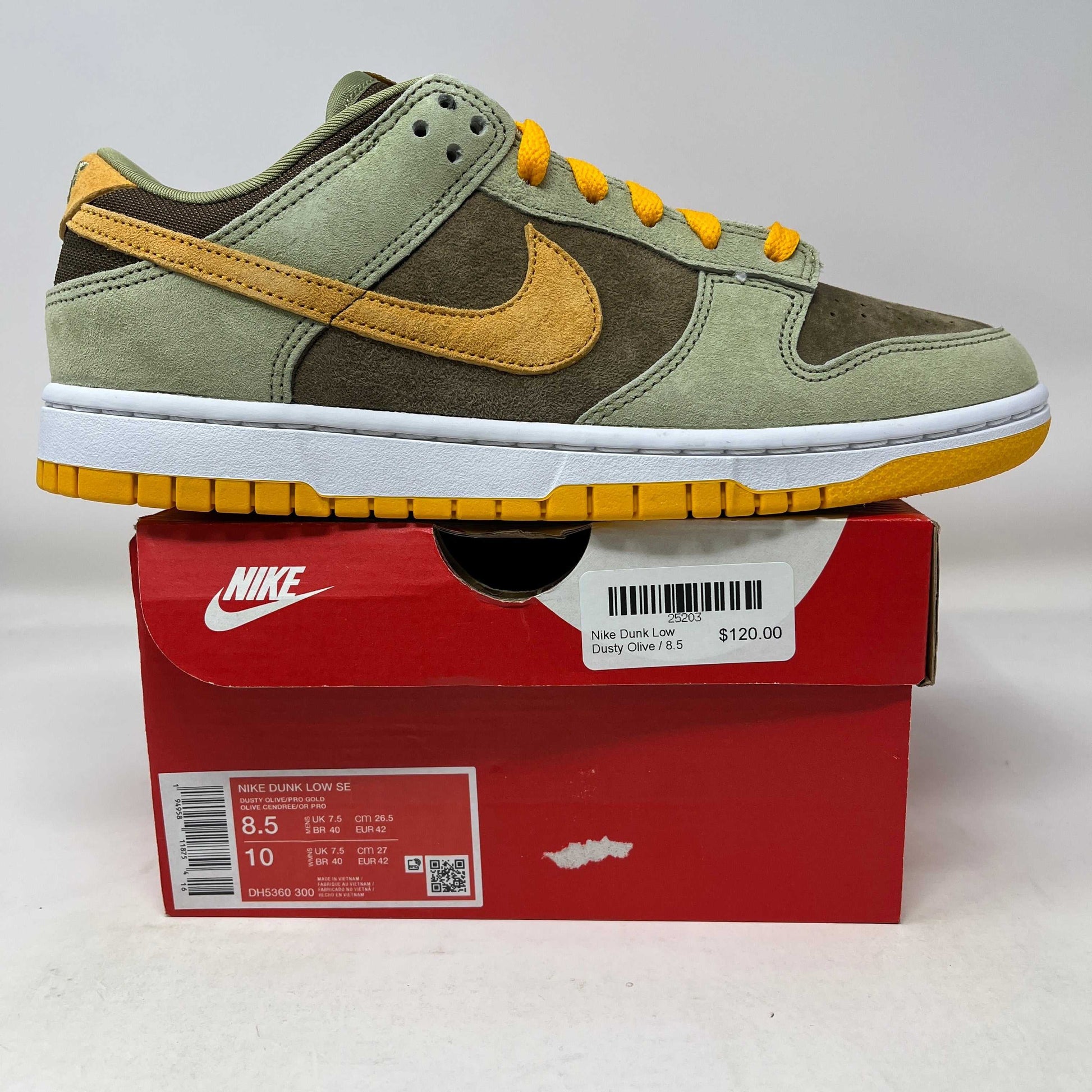 Nike Dunk Low Dusty Olive sneaker in green and mustard on red Nike box with price tag $120