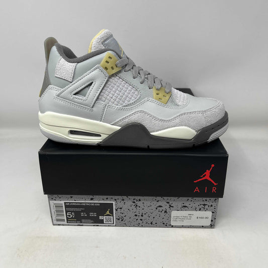 Jordan 4 Retro SE Craft Photon Dust GS sneaker in grey and cream colors on black Air Jordan box