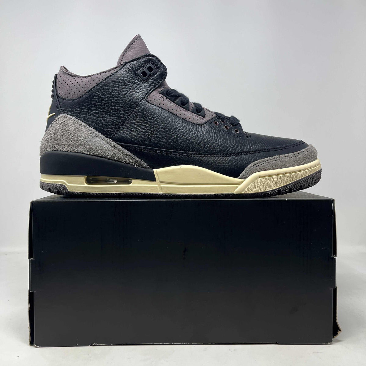 Jordan 3 Retro OG SP sneaker in black textured leather with gray suede overlays, mauve accents, and a cream midsole.