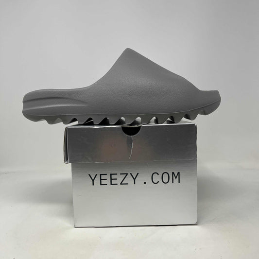 Grey molded foam YZY YS-01 Grey slide with a smooth, one-piece upper and distinctive ridged sole.