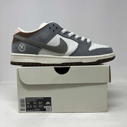 Nike SB Dunk Low Yuto Horigome sneaker in grey and white leather and suede, with Swoosh and heel emblem.