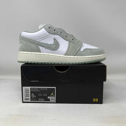 Side view of Jordan 1 Low SE White Seafoam GS sneaker on black box with label and size 5Y displayed