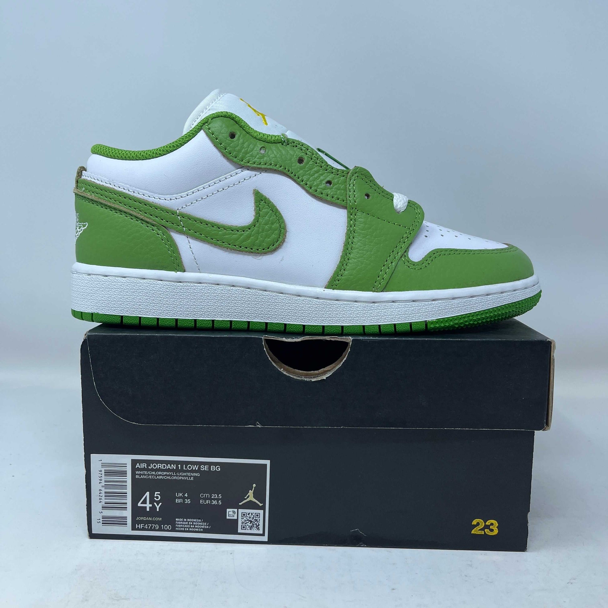 Jordan 1 Low Chlorophyll GS sneaker in white and green on black box with size label.