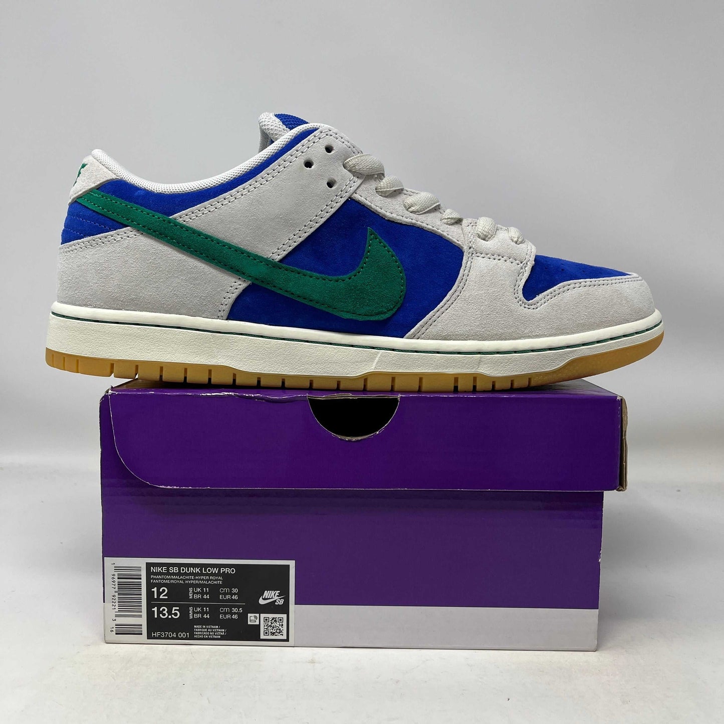 Nike SB Dunk Low Hyper Royal Malachite sneaker in blue, green, and gray on purple box, size 12 and 13.5